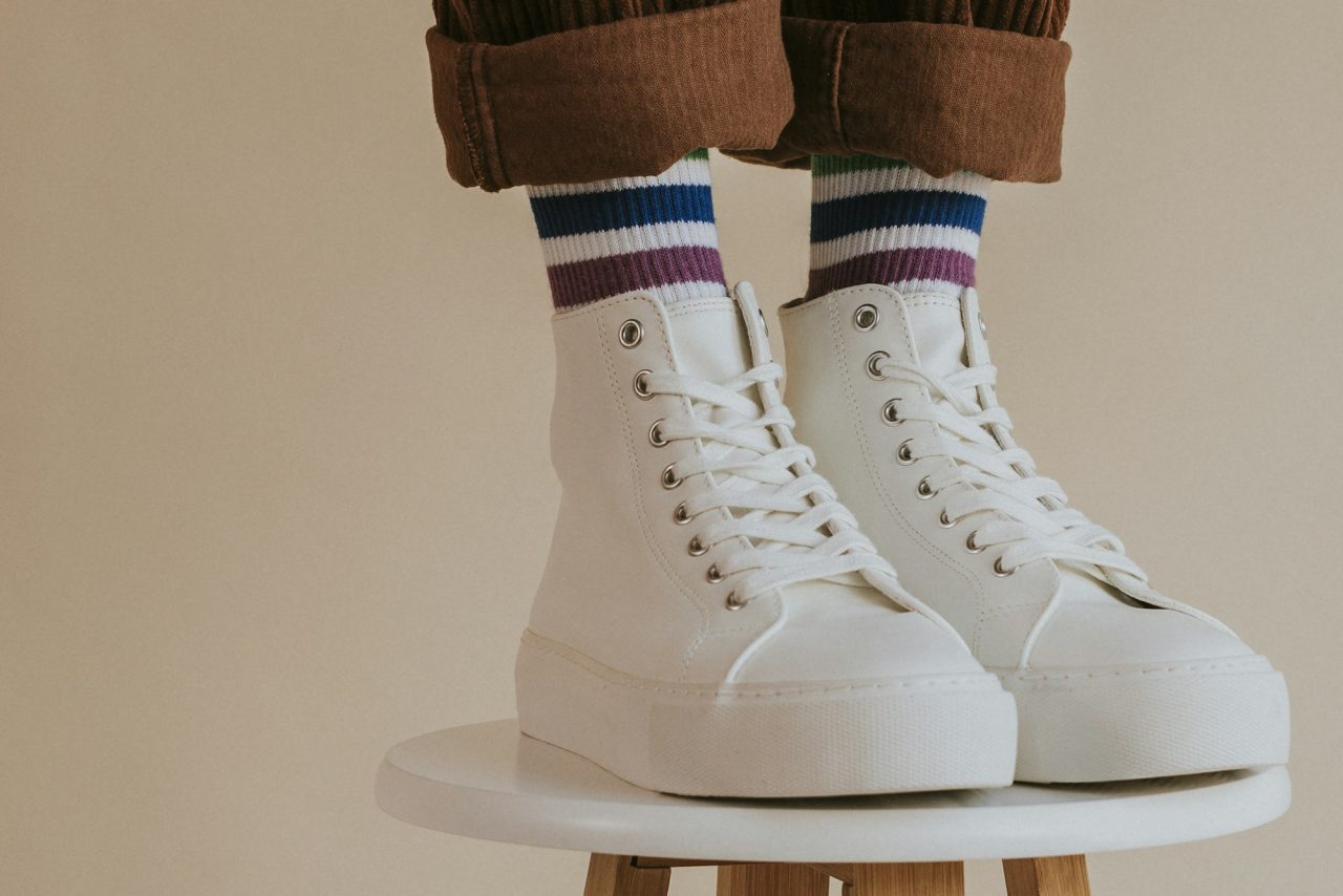 man-in-white-high-top-shoes-standing-on-chair